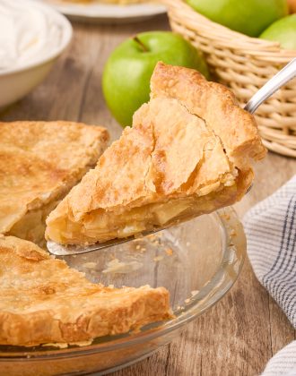 A slice of maple cream apple pie being removed from the pie.