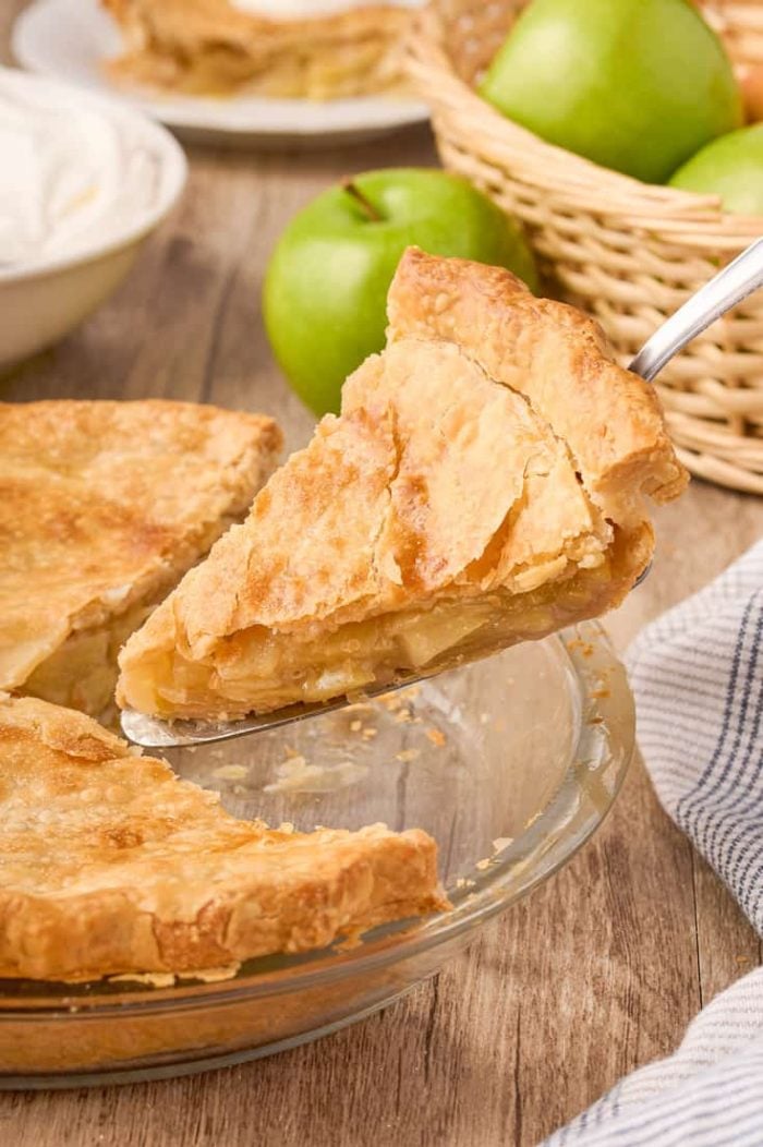 A slice of maple cream apple pie being removed from the pie.
