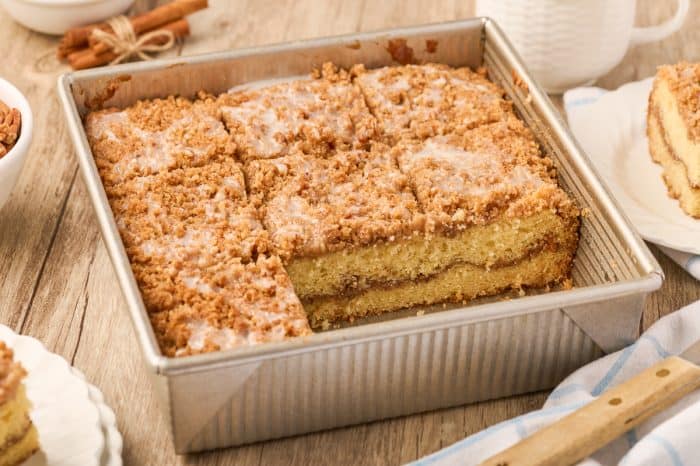 A pan of sour cream coffee cake cut into servings.