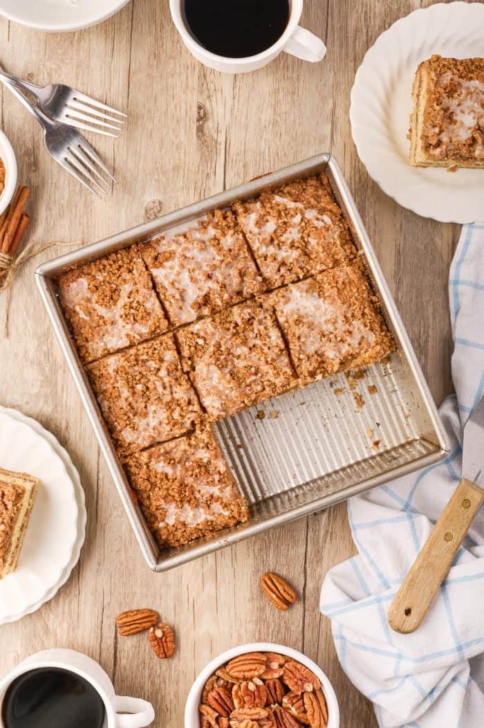 Sour cream coffee cake in a baking pan cut into servings.