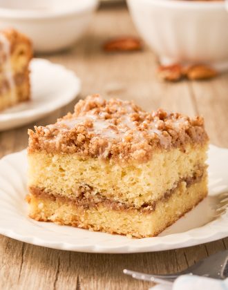 A slice of sour cream coffee cake on a plate.