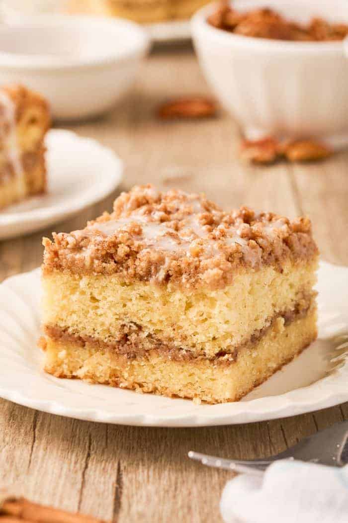 A slice of sour cream coffee cake on a plate.