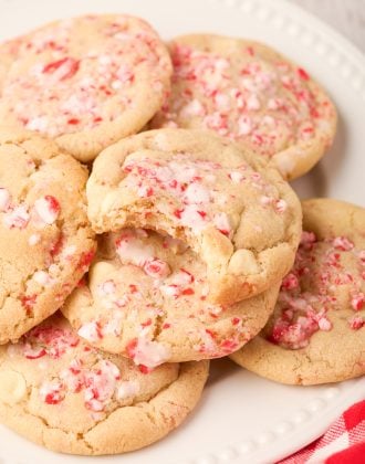 Peppermint white chocolate cookies on a plate with a bite out of one.