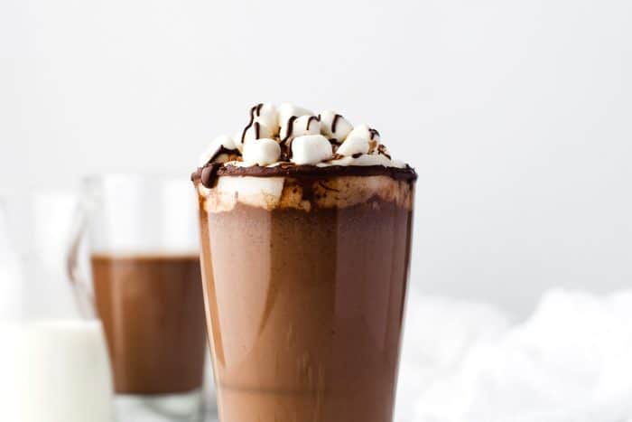 Hot chocolate in a glass with marshmallows.