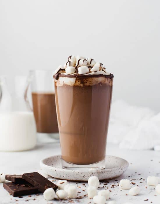 Hot chocolate in a glass with marshmallows.
