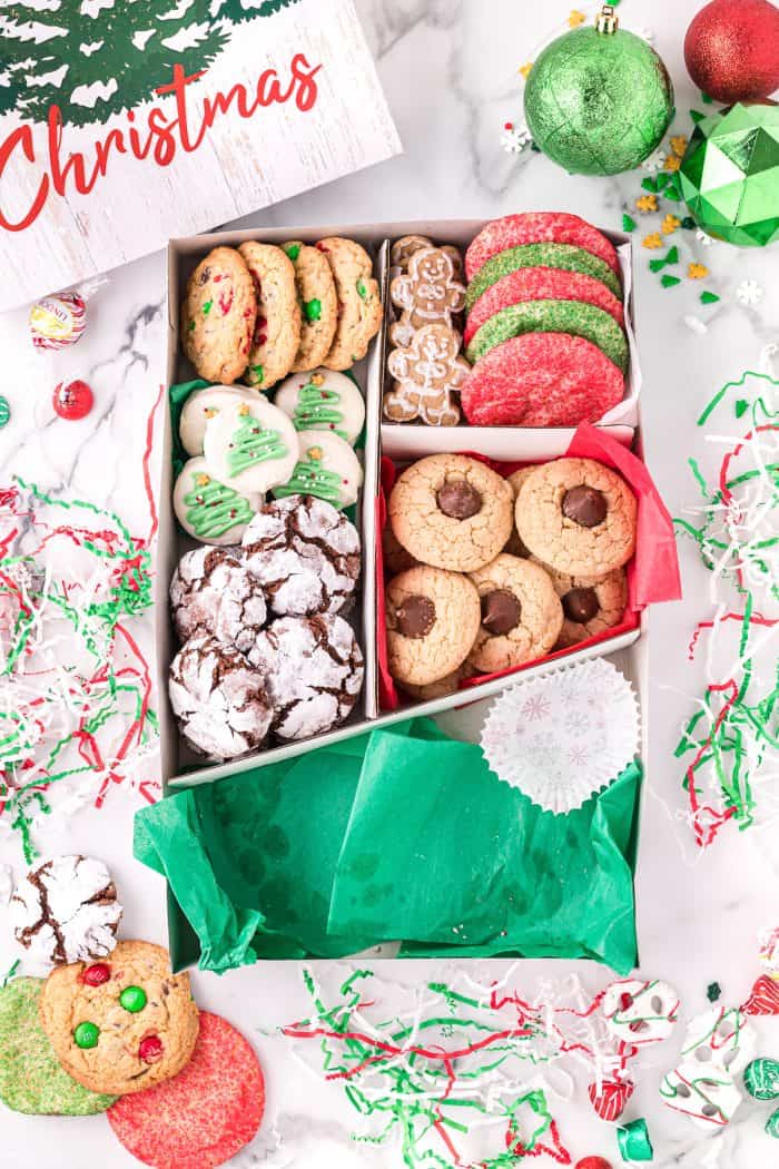 Placing cookies into a holiday cookie box.