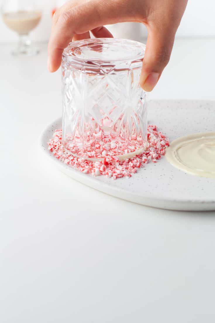 Dipping the glass into crushed candy cane.