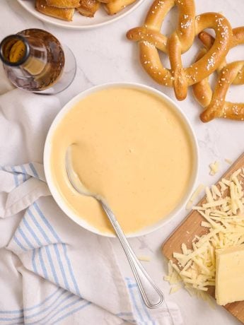 Beer cheddar cheese dip with a spoon in it.
