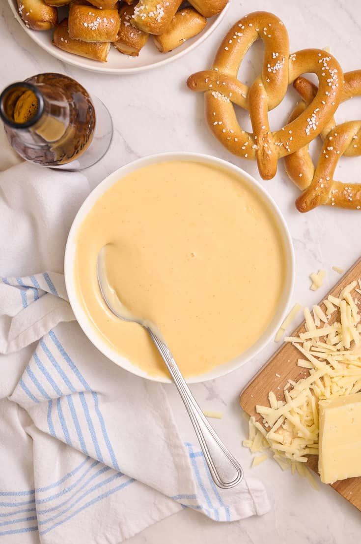 Beer cheddar cheese dip with a spoon in it. 