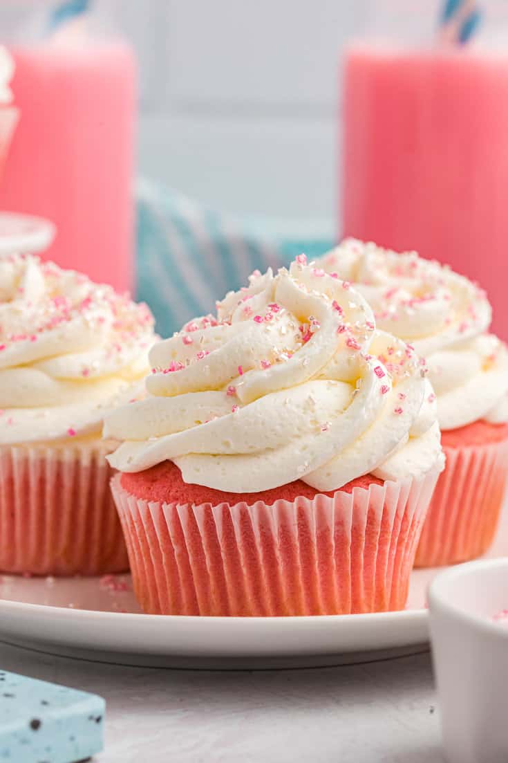Pink velvet cupcakes on a white plate.