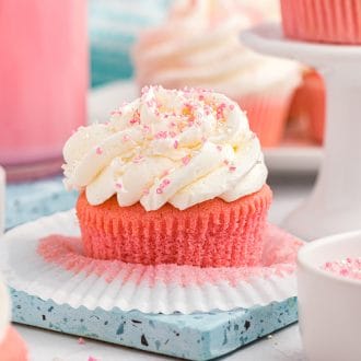 Pink velvet cupcakes on a blue plate.