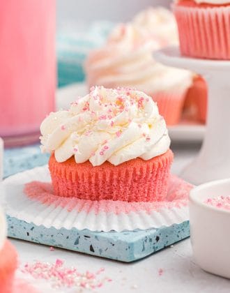 Pink velvet cupcakes on a blue plate.