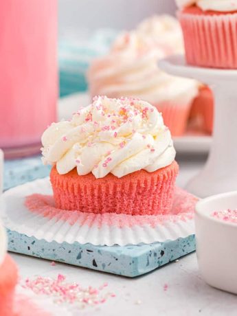 Pink velvet cupcakes on a blue plate.