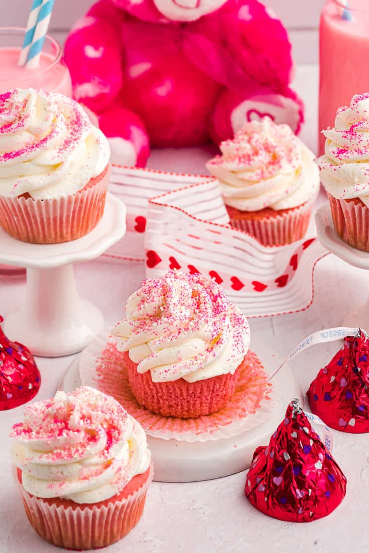 Pink velvet cupcakes on a white plate. 