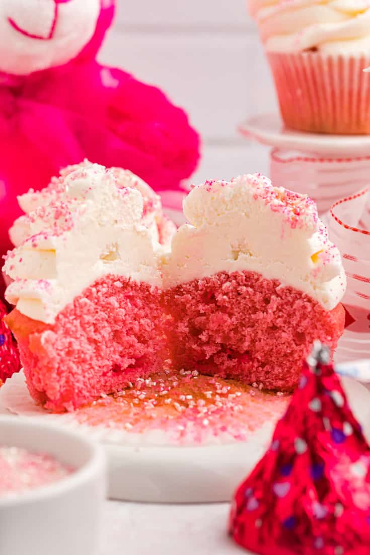 A pink velvet cupcake cut in half. 