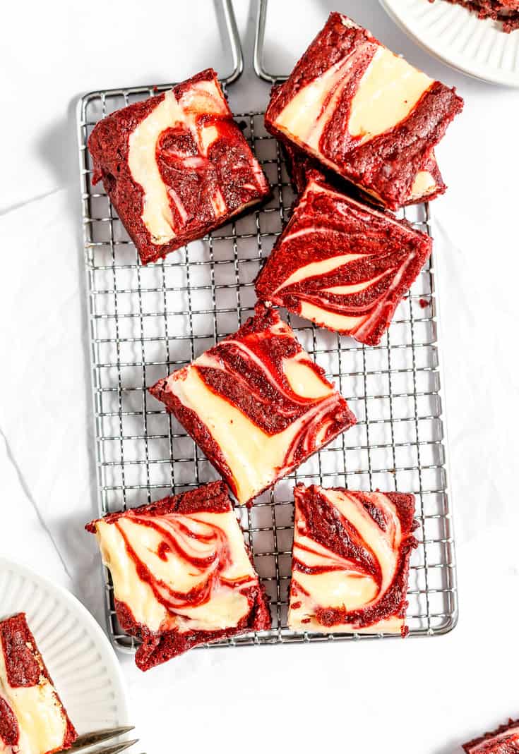 Red velvet cheesecake brownies on a cooling rack. 