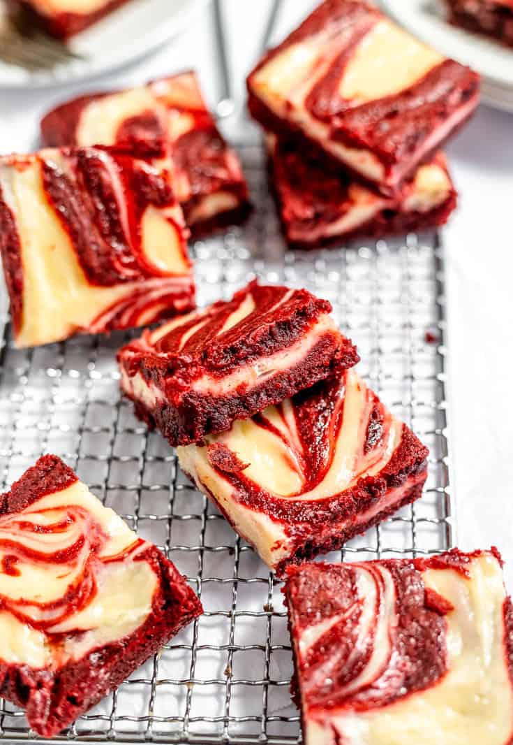 Red velvet cheesecake brownies on a cooling rack. 