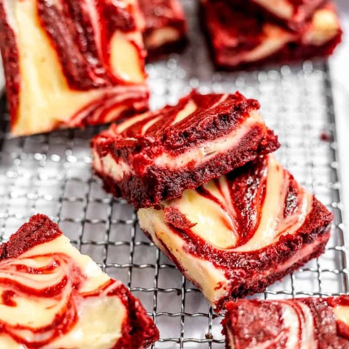 Red velvet cheesecake brownies on a cooling rack.