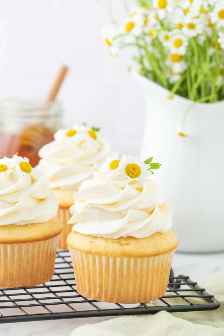 Chamomile cupcakes on a cooling rack.