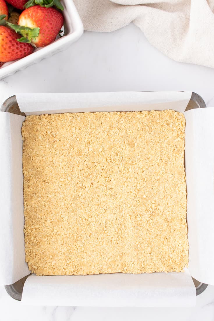 Cheesecake crust pressed into a baking pan. 