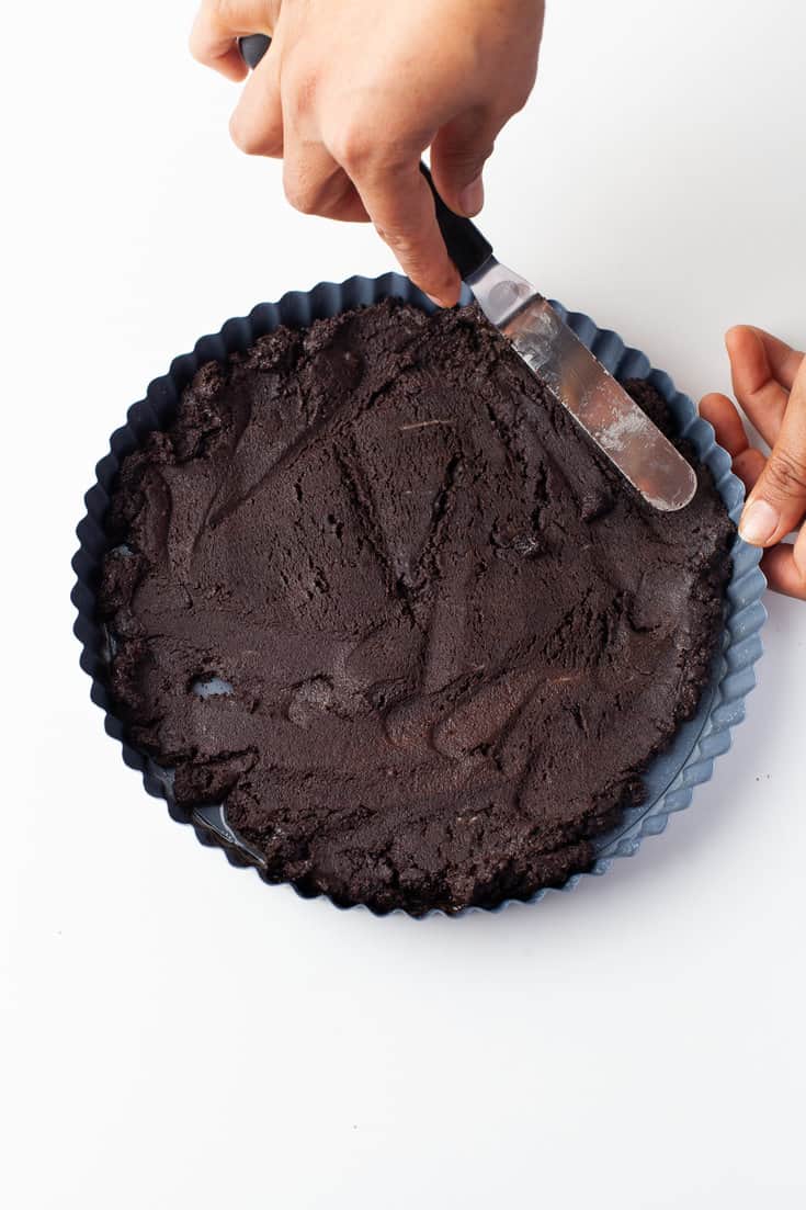Pressing the tart ingredients into the tart pan for the No Bake Chocolate Tart 