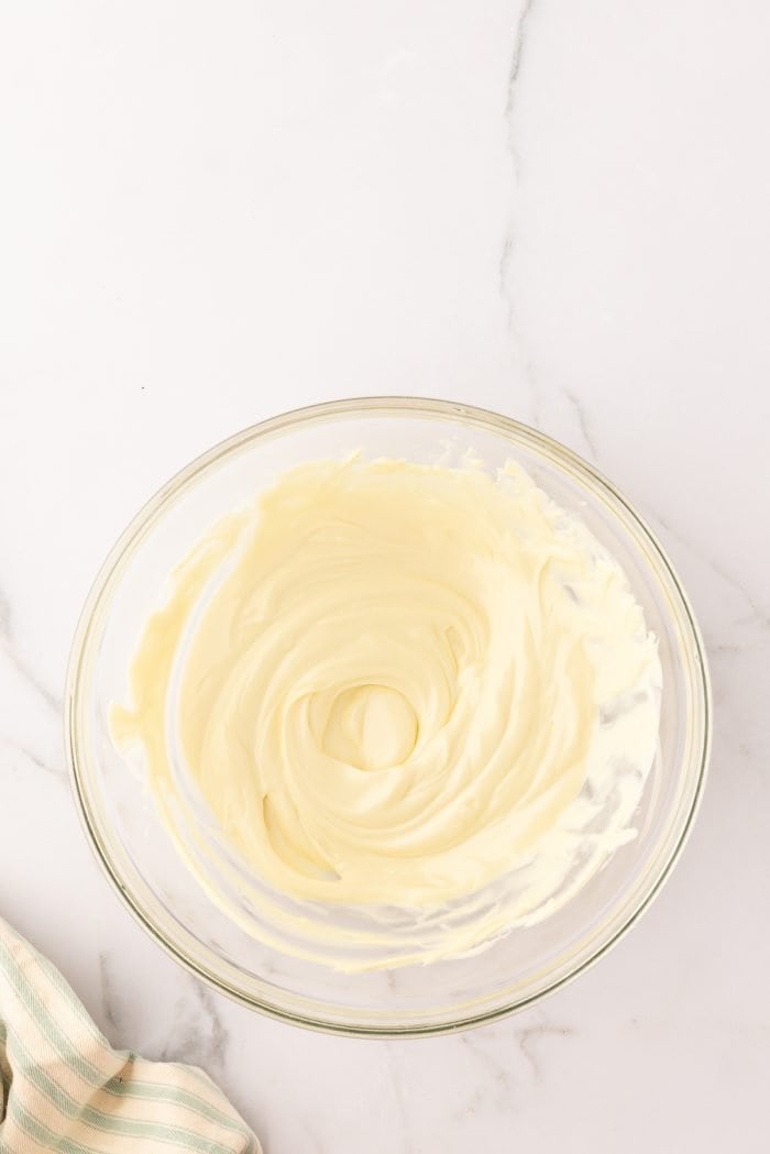 Melted white chocolate in a glass bowl.