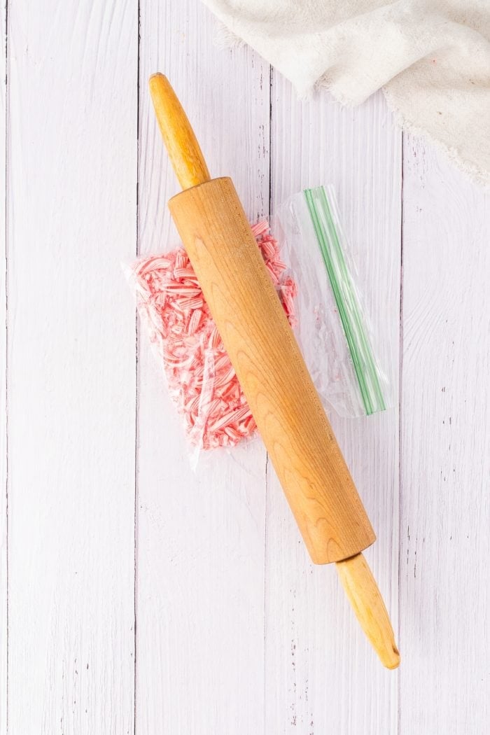 Crushing the candy canes with a rolling pin.
