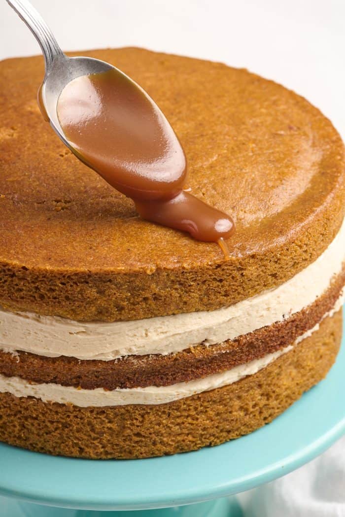 Topping the pumpkin cake with caramel.