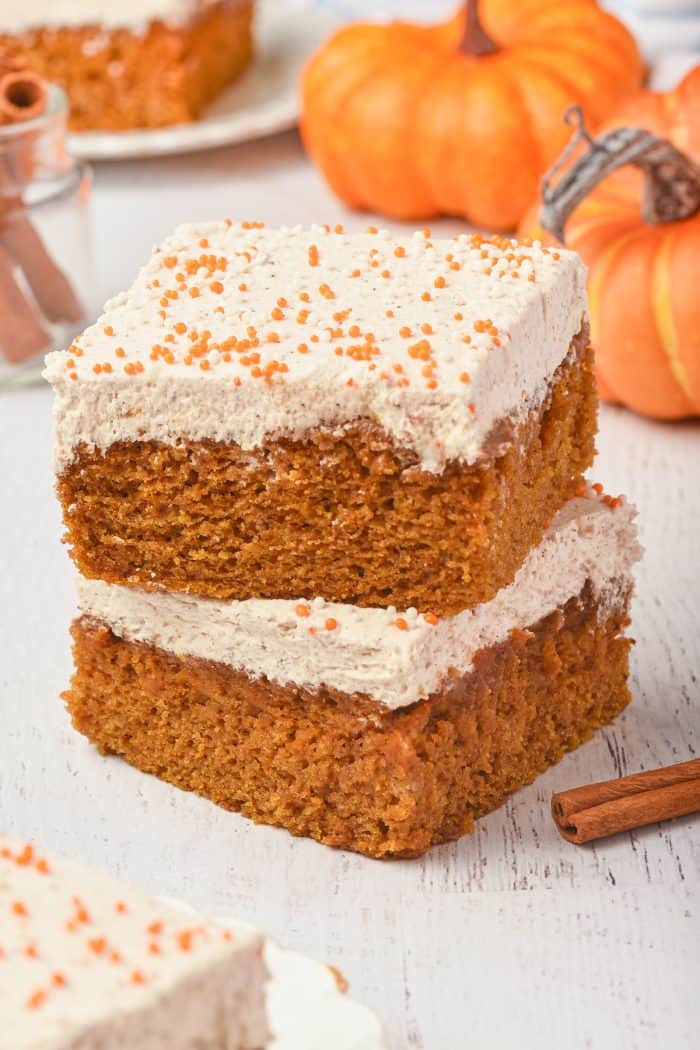 A picture of two pumpkin cake bars on top of each other.