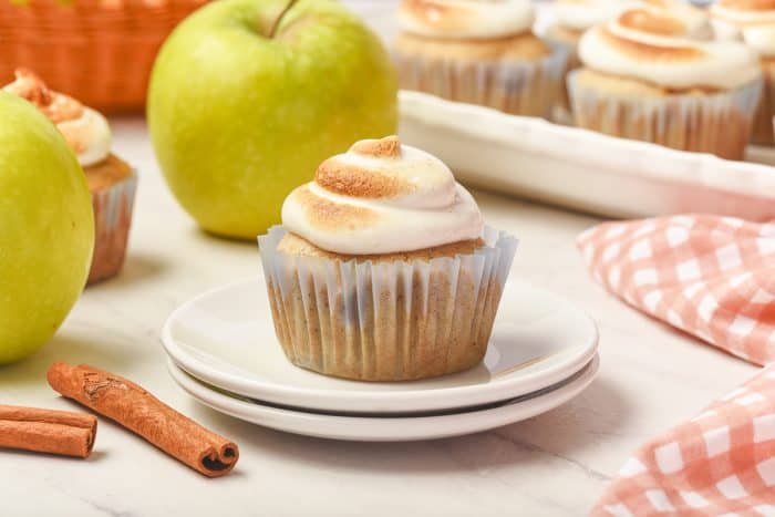 A spiced apple cupcake sitting on two white plates.