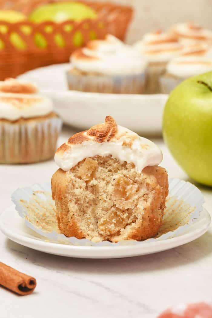 A spiced apple cupcake with a bite out of it.