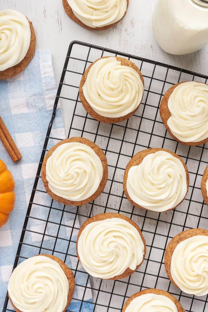 A cooling rack with frosted pumpkin snickerdoodles.