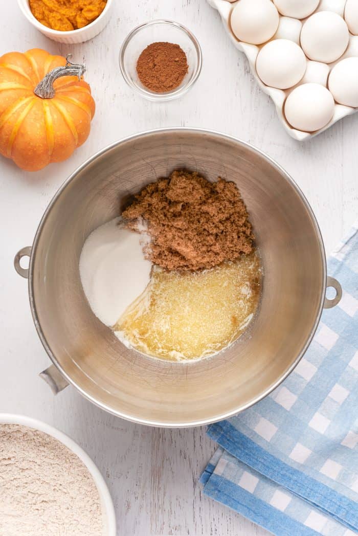 A mixing bowl with brown sugar, sugar, and melted butter.