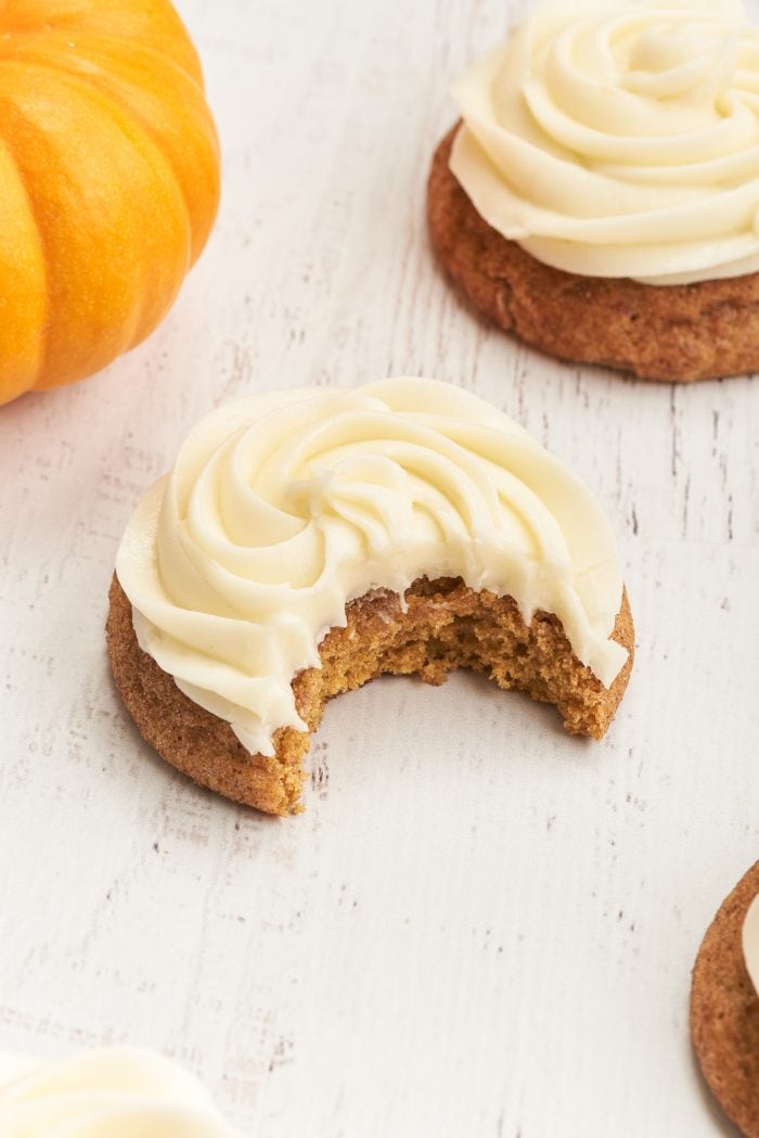 A closeup of a pumpkin snickerdoodle with cream cheese frosting. 