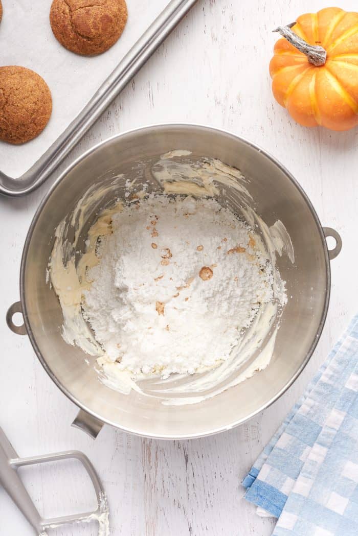 Cream cheese mixed with icing sugar in a mixing bowl.