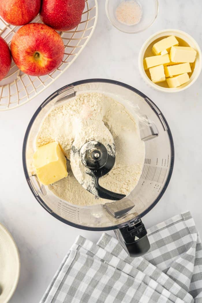 A food processor filled with flour and butter.