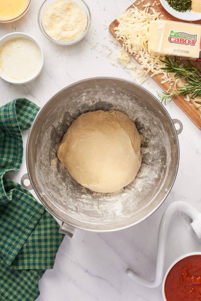 The dough formed in a mixing bowl before allowing it to rise.