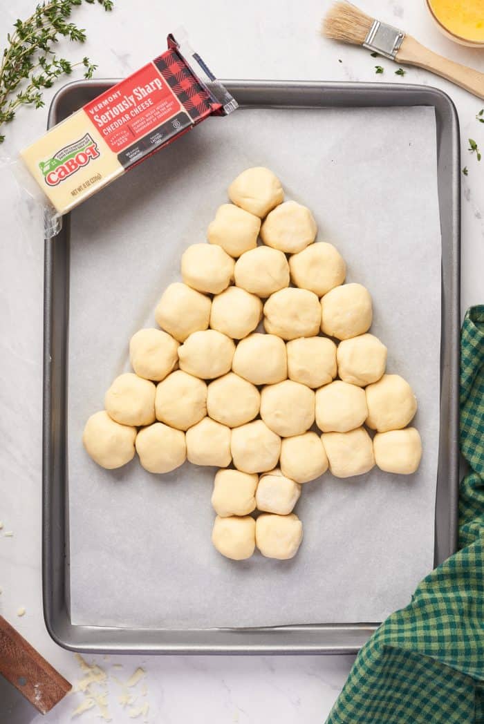 The dough balls formed into a tree on a baking sheet.