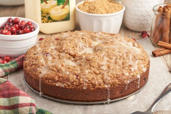 An image of the whole cranberry eggnog coffee cake with icing dripping over it.