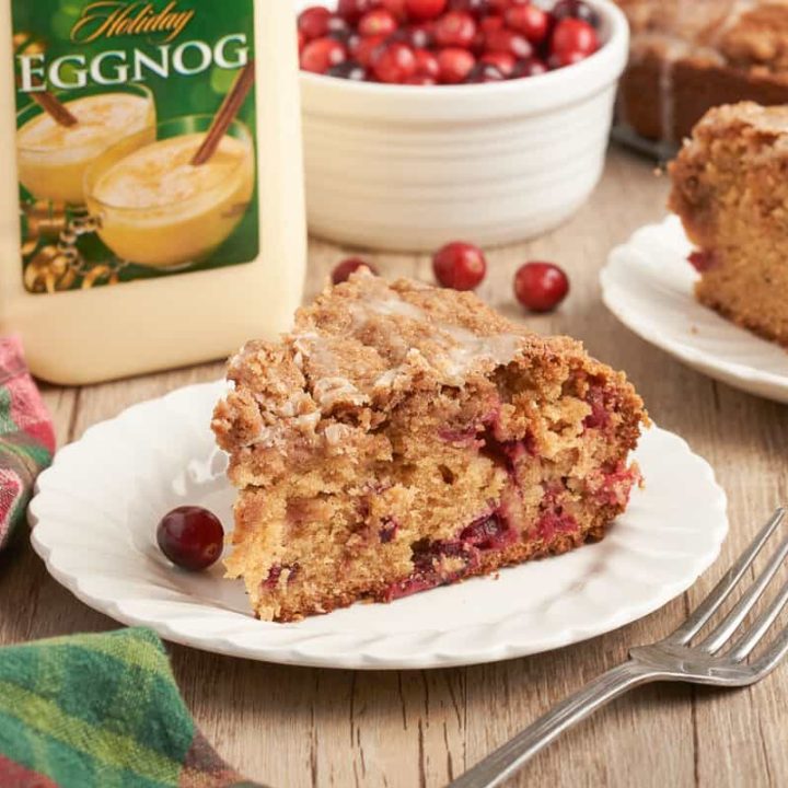 A slice of cranberry eggnog coffee cake on a white plate.