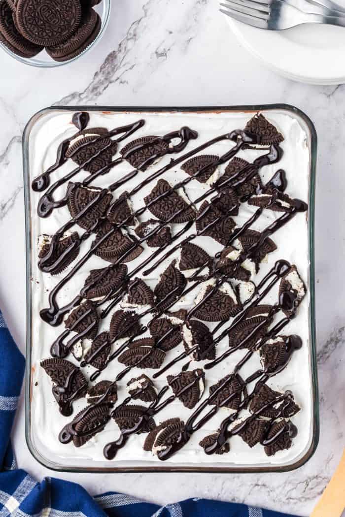 A glass dish filled with no bake Oreo layered dessert.