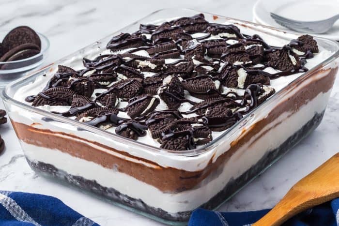 No bake Oreo layered dessert in a glass serving dish.