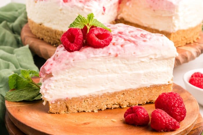 An up close image of a slice of no bake raspberry lemon cheesecake.