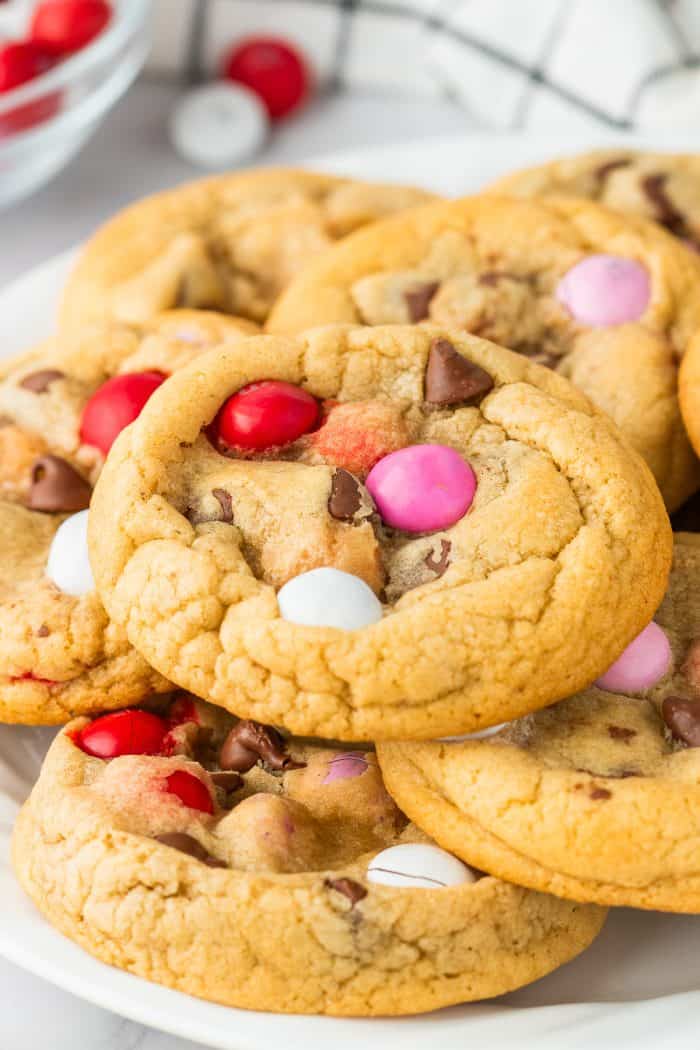 A pile of Valentine's M&M Cookies on a plate.