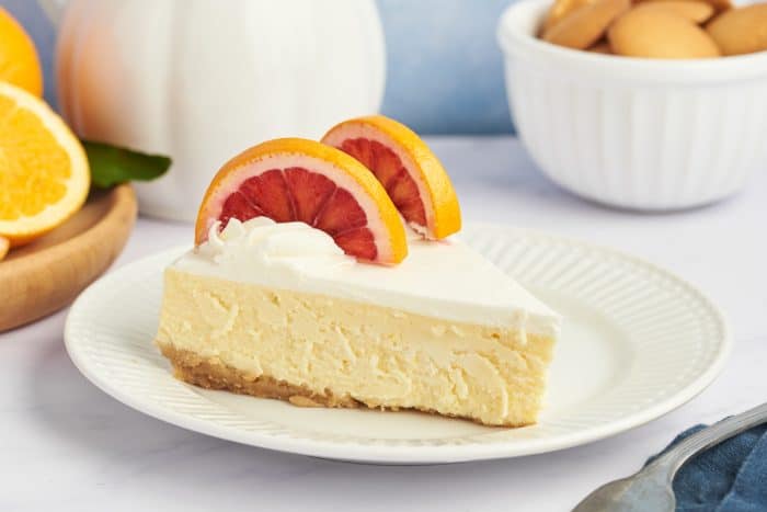 A slice of cheesecake on a white plate. 