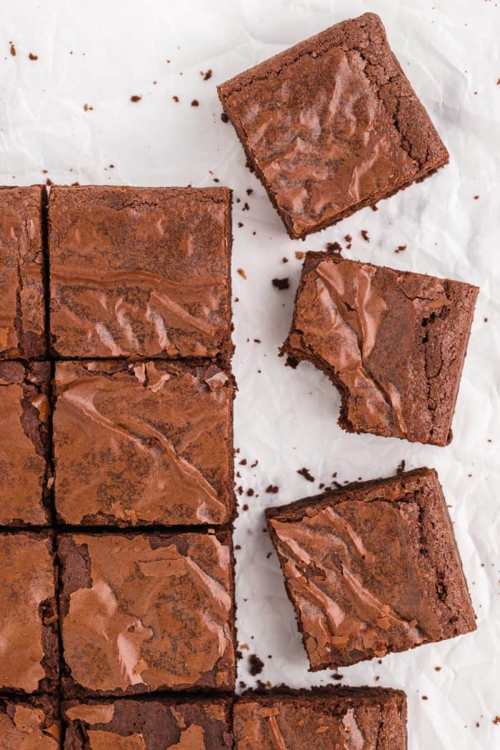 An overview image of the tops of brownies on a white background.