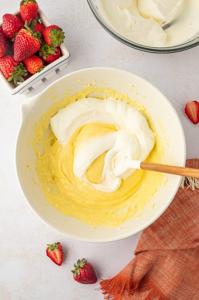 Whipped cream being mixed with pudding.