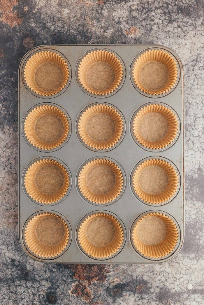 A muffin pan filled with muffin liners.