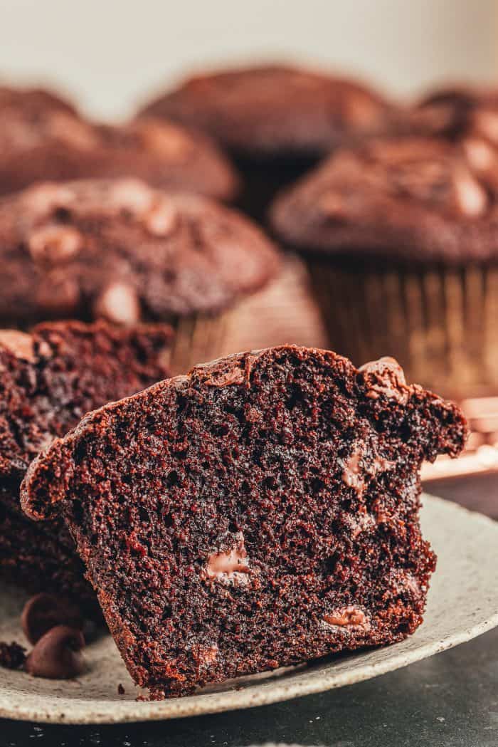 A double chocolate muffin that has been sliced in half to show how chocolatey it is. 
