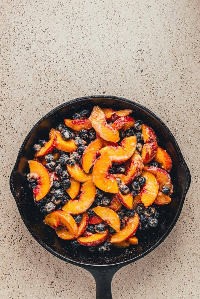 A cast-iron skillet with the crumble filling in it.